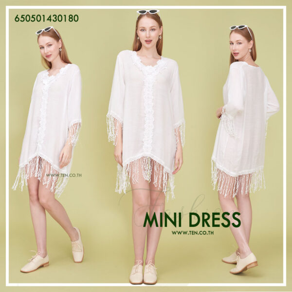 Romantic white dress with floral lace details and fringe hem