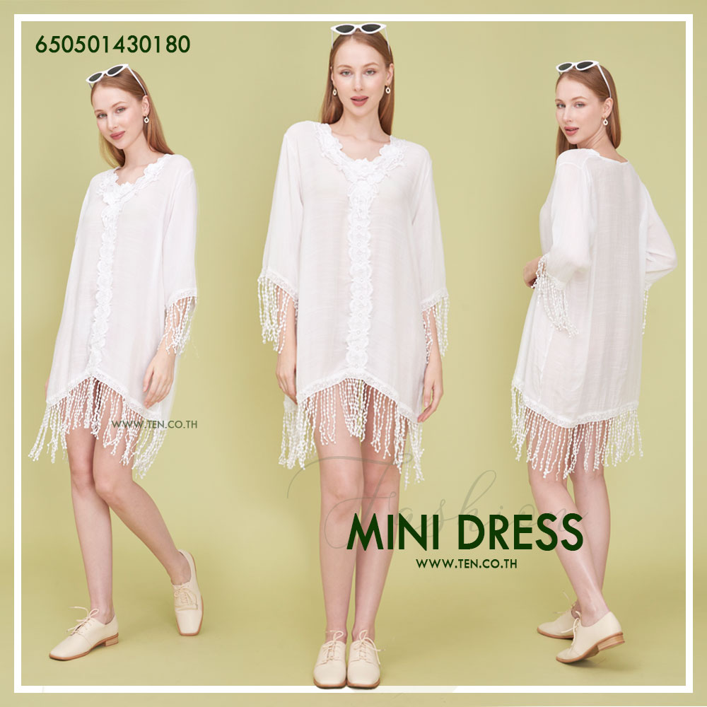 Romantic white dress with floral lace details and fringe hem