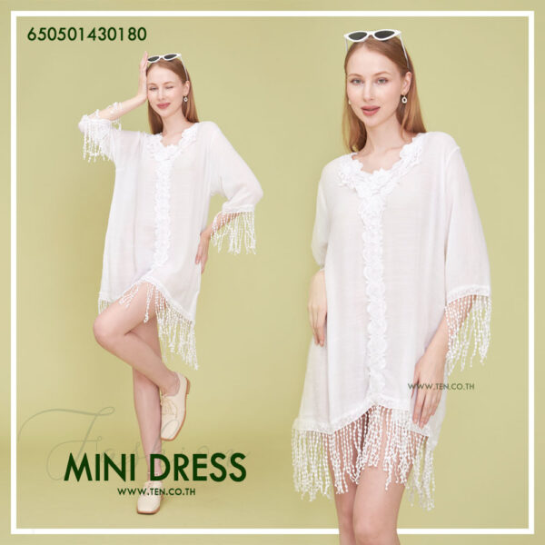 Romantic white dress with floral lace details and fringe hem