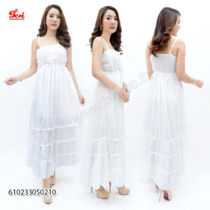 Cream ruffle maxi dress with tiered layers, paired with a straw bag.