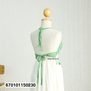 Elegant floral crochet maxi dresses in green and brown on display in a minimalist interior.