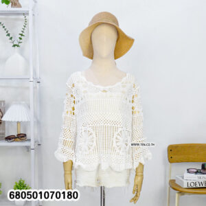Boho-style long sleeve crochet blouse in cream and white, styled with straw hat and white shorts