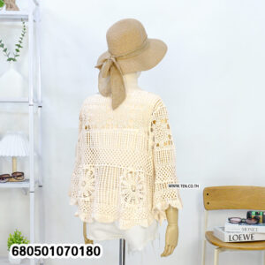 Boho-style long sleeve crochet blouse in cream and white, styled with straw hat and white shorts