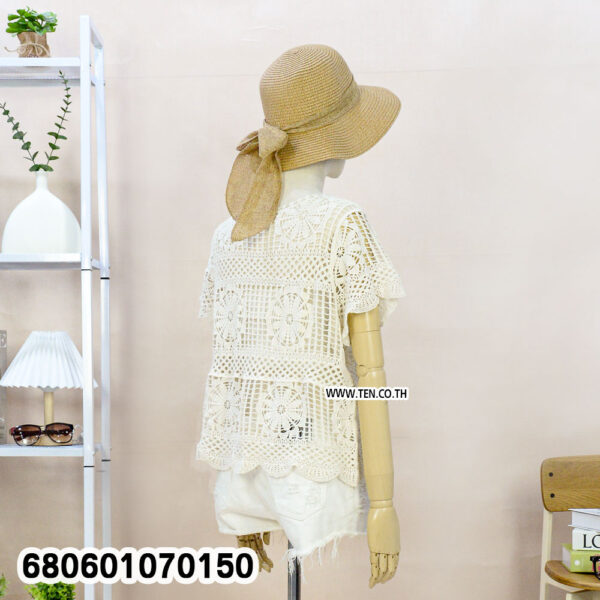 Front and back views of a handmade crochet summer blouse styled with straw hat and white shorts