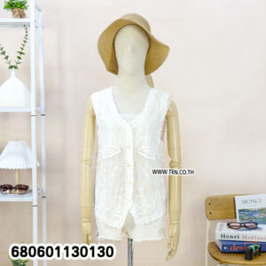 Casual white lace vest for women styled with a straw hat and white denim shorts