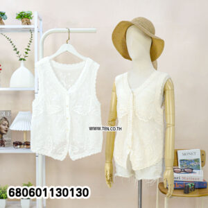 Casual white lace vest for women styled with a straw hat and white denim shorts