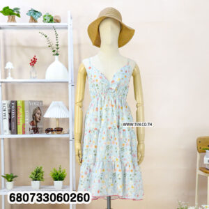 Three sleeveless tiered mini dresses in light floral prints (light blue, light pink, and cream/yellow), hanging on a rack and one on a mannequin.