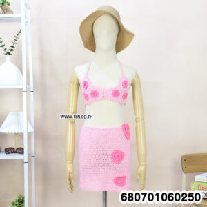 Boho crochet set with top and mini skirt on mannequin and rack, styled with beach accessories
