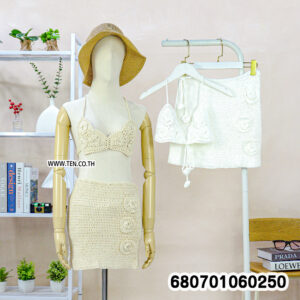 Boho crochet set with top and mini skirt on mannequin and rack, styled with beach accessories