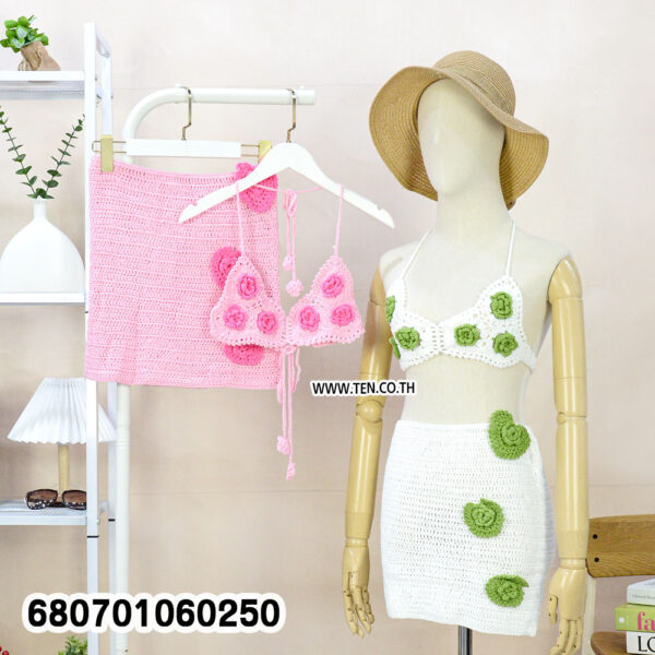 Boho crochet set with top and mini skirt on mannequin and rack, styled with beach accessories