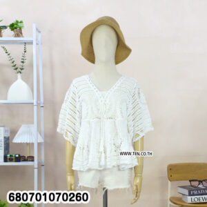 Casual white crochet lace blouse paired with shorts, displayed in a minimal setting.