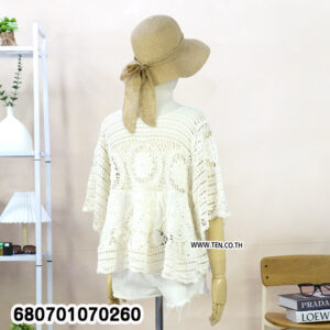 Casual white crochet lace blouse paired with shorts, displayed in a minimal setting.
