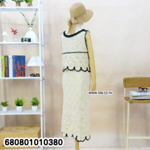 White crochet matching set with black trim, sleeveless top and midi skirt displayed on mannequin