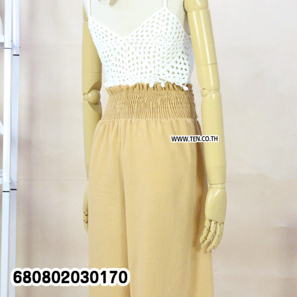 Summer palazzo pants styled with a straw hat and white crochet top on a mannequin