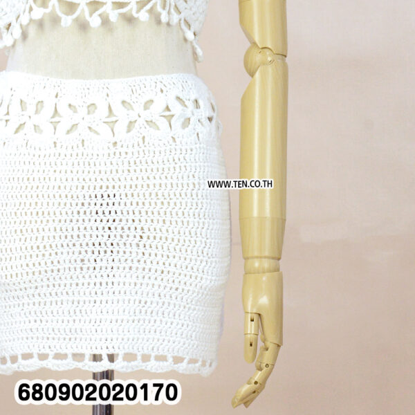 "White handmade crochet mini skirt styled with floral waist detail and boho design"