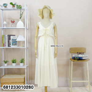 Sleeveless flowy white cotton maxi dress with ruffle neckline and lightweight fabric for summer and beachwear