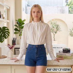 White and black Victorian style floral sheer blouse with embroidery and button front displayed on mannequin.