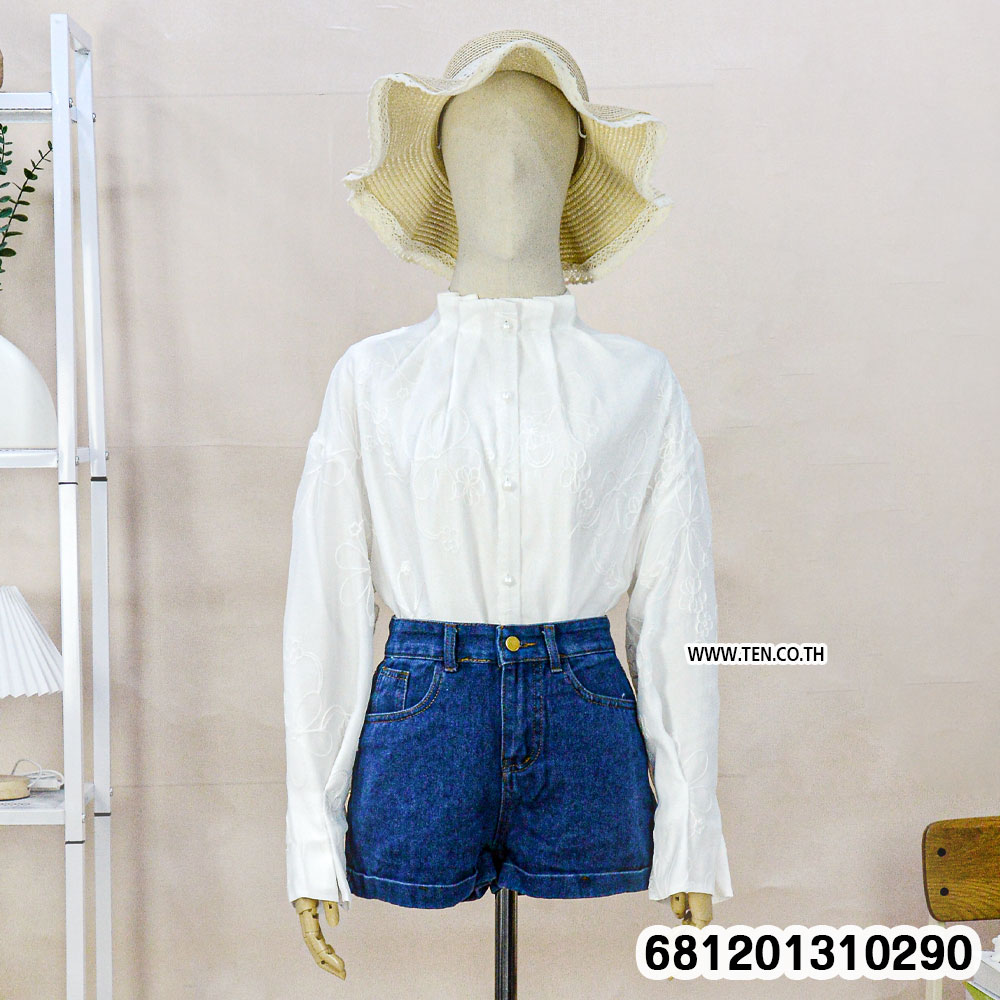 White and black Victorian style floral sheer blouse with embroidery and button front displayed on mannequin.