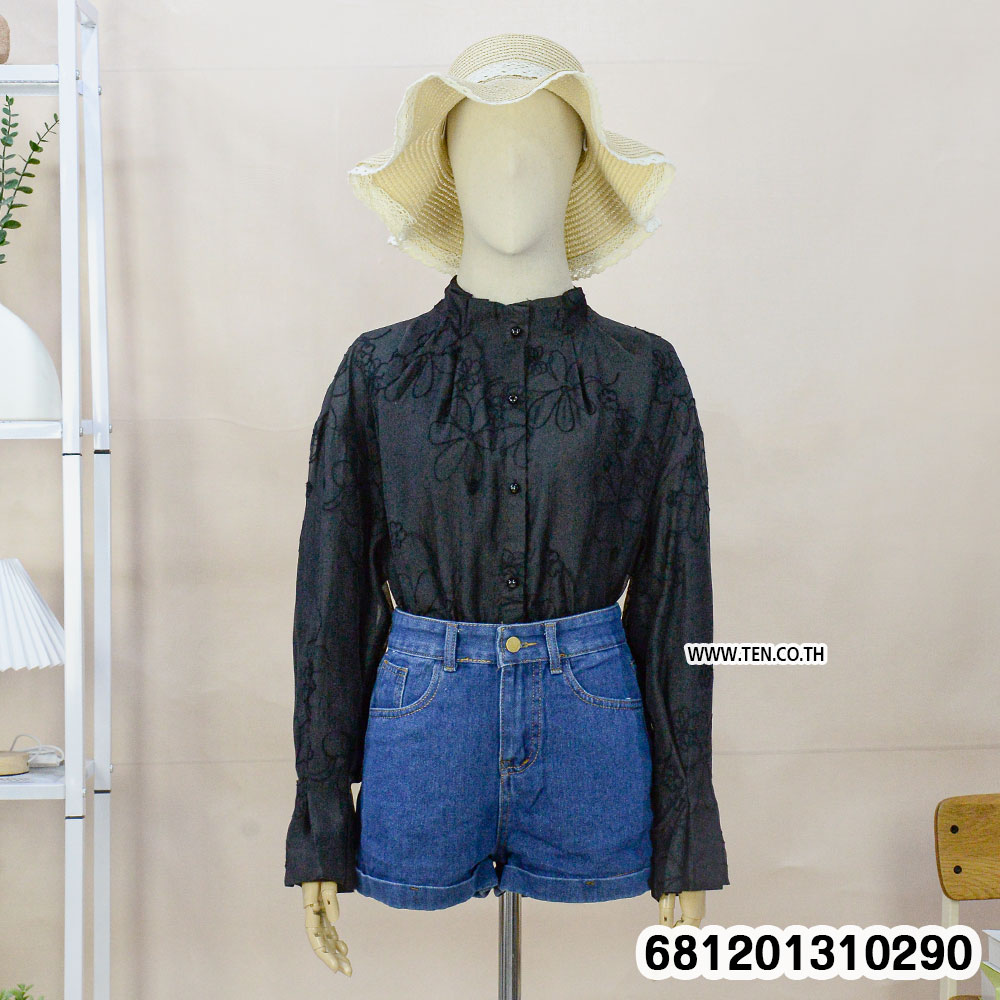 White and black Victorian style floral sheer blouse with embroidery and button front displayed on mannequin.