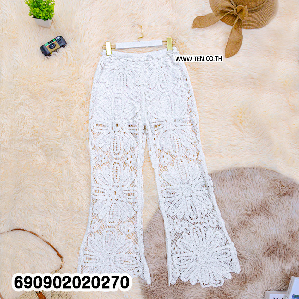 Sheer floral lace resort pants in beige and white with large floral openwork and shaped hems