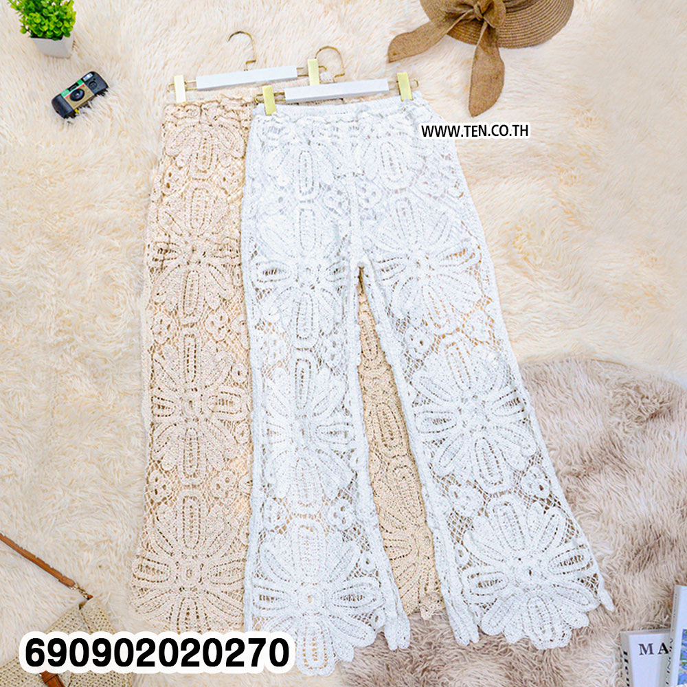 Sheer floral lace resort pants in beige and white with large floral openwork and shaped hems